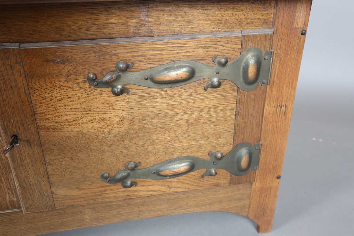 An Edwardian Arts and Crafts oak wall cabinet, in the manner of Liberty & Co, with coppered hinge - Image 6 of 13