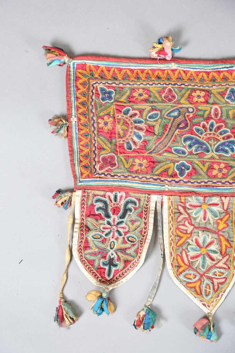 An Indian kutch embroidered door hanging, finely worked in coloured threads, width 98cm. Provenance: - Image 5 of 6