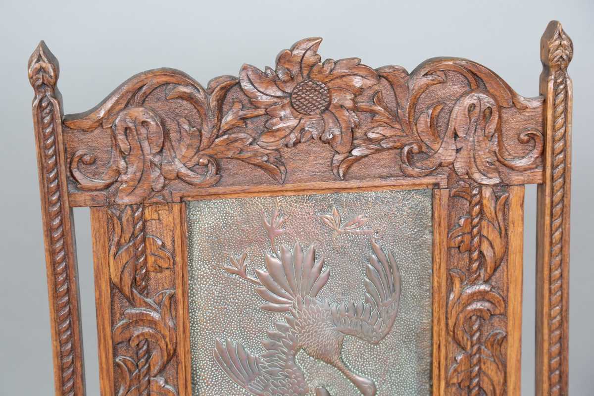 A late Victorian Arts and Crafts oak framed and copper inset firescreen, the panel worked with - Image 2 of 7