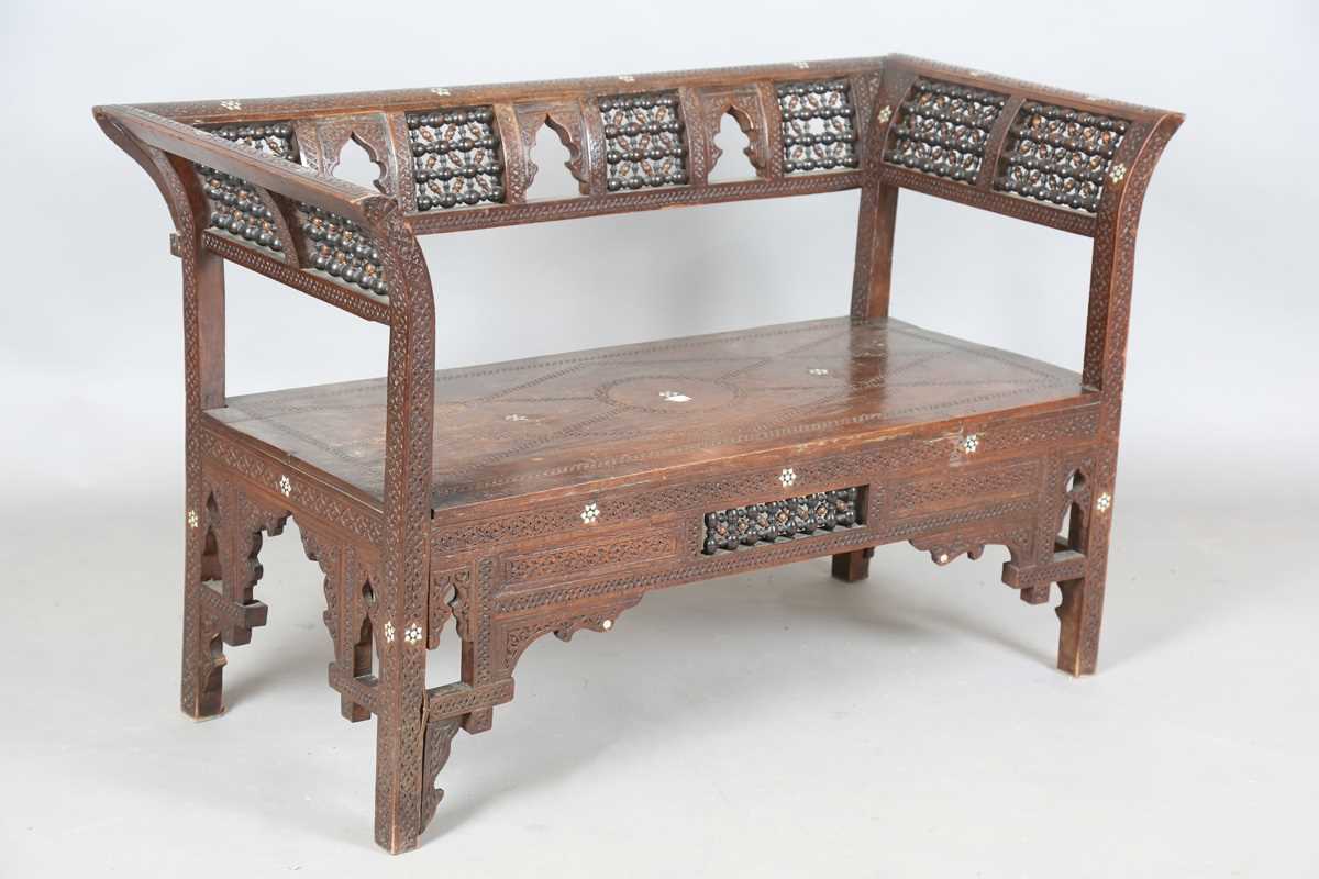 A late 19th century Middle Eastern hardwood and mother-of-pearl inlaid window seat, similar to those