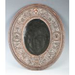 A 19th century Italian carved wooden oval wall mirror, the finely worked frame detailed 'Sienna