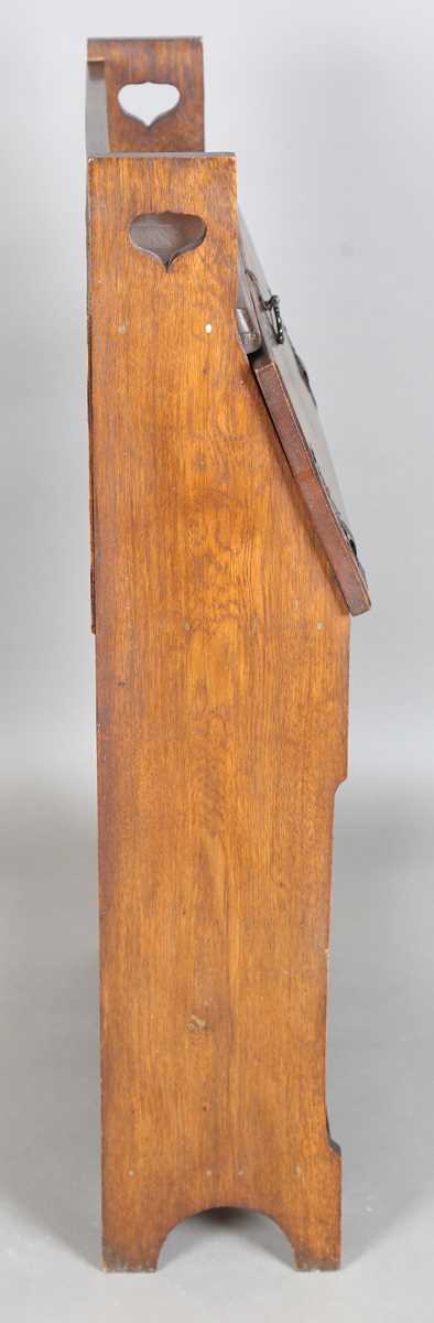 An early 20th century Arts and Crafts oak student's bureau, in the manner of Liberty & Co, height - Image 8 of 11
