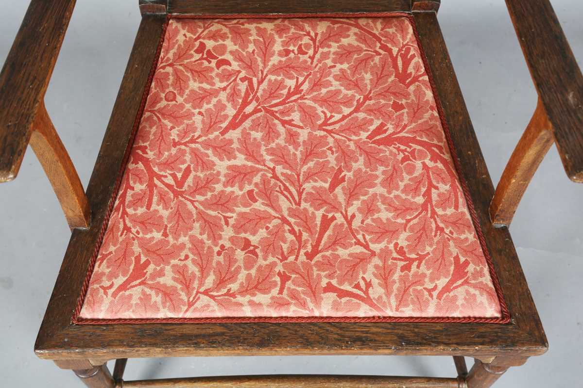 An Edwardian Arts and Crafts oak framed elbow chair, attributed to J.S. Henry, with later fitted - Image 5 of 11