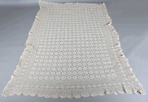 A large Edwardian crochet bedspread, worked with overall roundels, within a border of flowerheads,