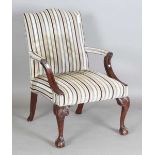 A 20th century George III style mahogany Gainsborough armchair, raised on carved cabriole legs,