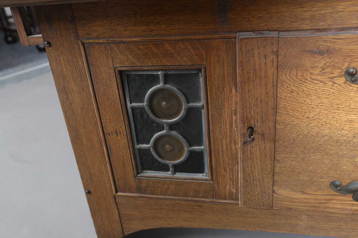 An Edwardian Arts and Crafts oak wall cabinet, in the manner of Liberty & Co, with coppered hinge - Image 7 of 13