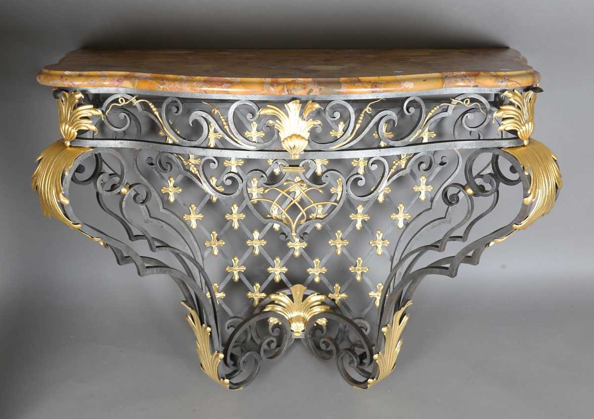 An impressive 20th century black and gilt painted wrought iron console table, the substantial Brèche
