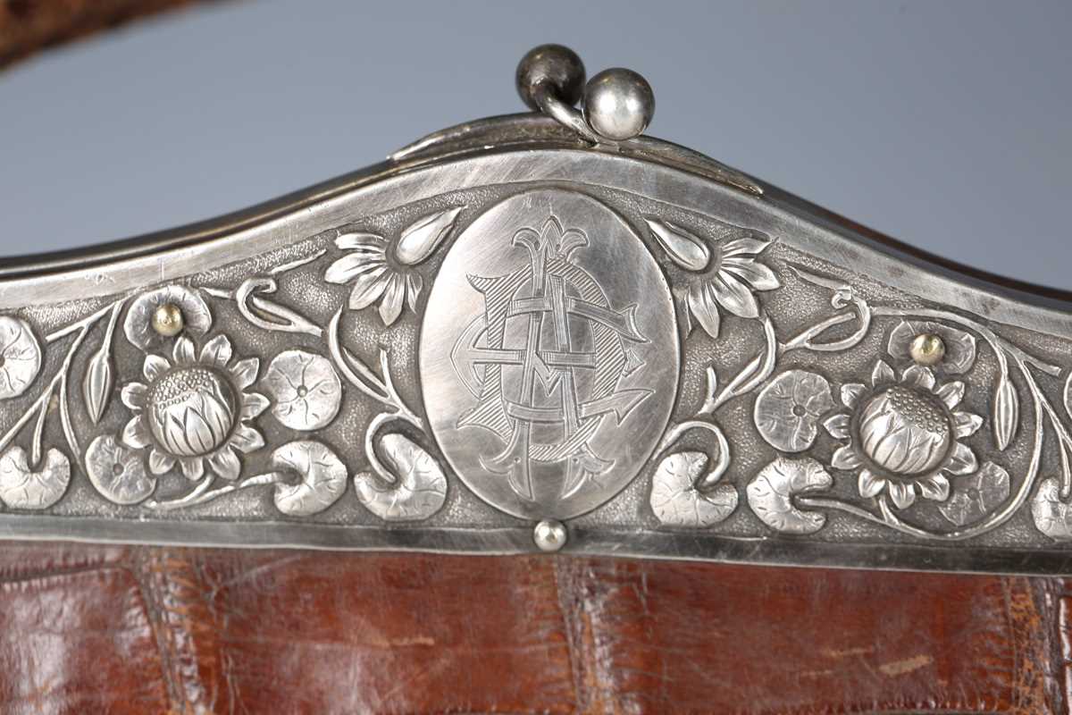 An early 20th century crocodile skin handbag, the white metal clasp decorated with lotus flowers and - Image 2 of 13