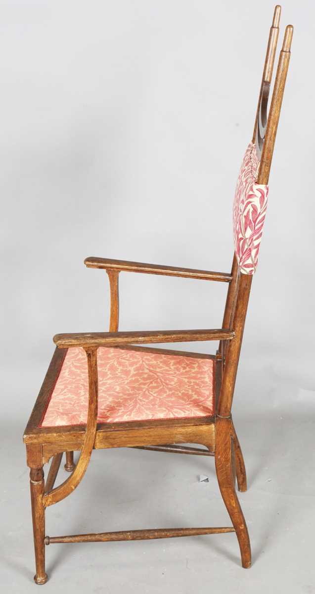 An Edwardian Arts and Crafts oak framed elbow chair, attributed to J.S. Henry, with later fitted - Image 10 of 11