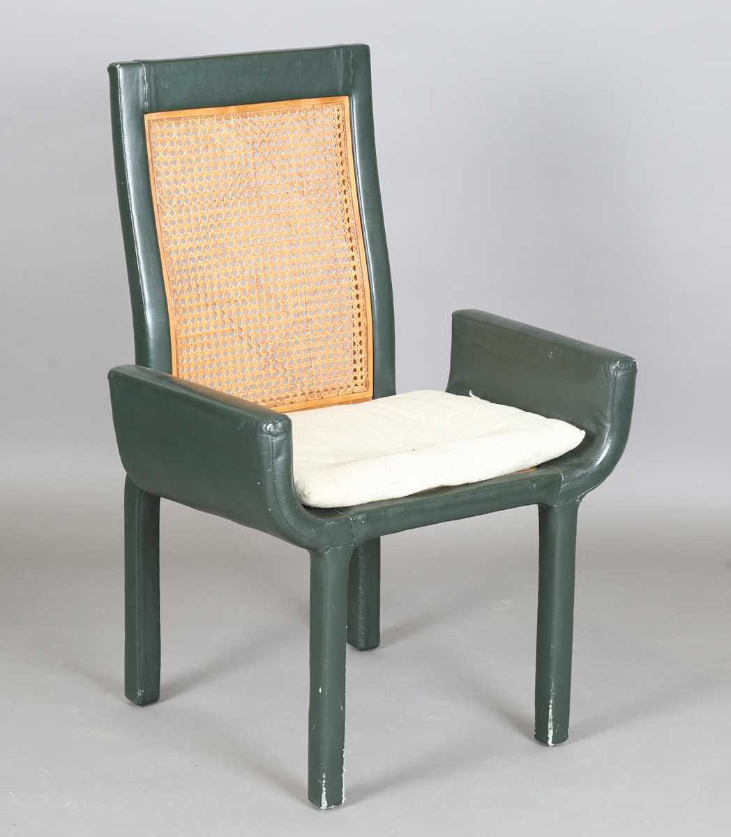 A John Makepeace satinwood and green leather covered armchair with a caned seat and back panel,