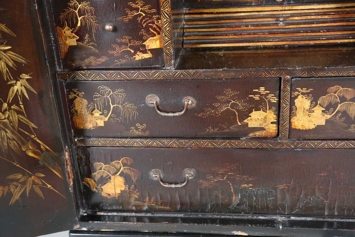 An 18th century Chinese black lacquered collector's cabinet, decorated in gilt with landscape - Image 4 of 28