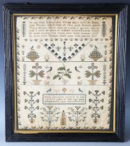 A William IV needlework sampler by Mary George, 'in the 12th year of her age', dated 1835, finely