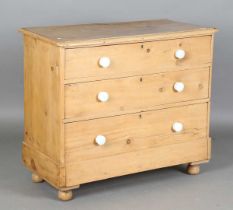 A Victorian pine chest of three long drawers, height 86cm, width 102cm, depth 50cm.