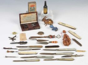 A mixed group of objects of virtu, including a late 19th century cast metal novelty tape measure