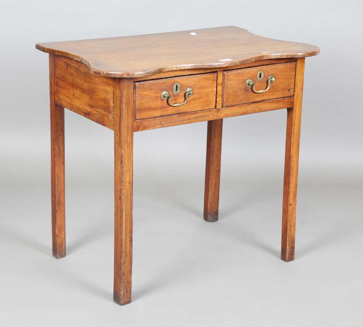 A George III mahogany side table, the later shaped top above two oak-lined drawers, height 71cm,