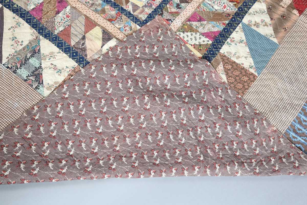 A large mid-19th century cotton 'medallion' patchwork quilt, finely worked with overall printed - Image 10 of 10