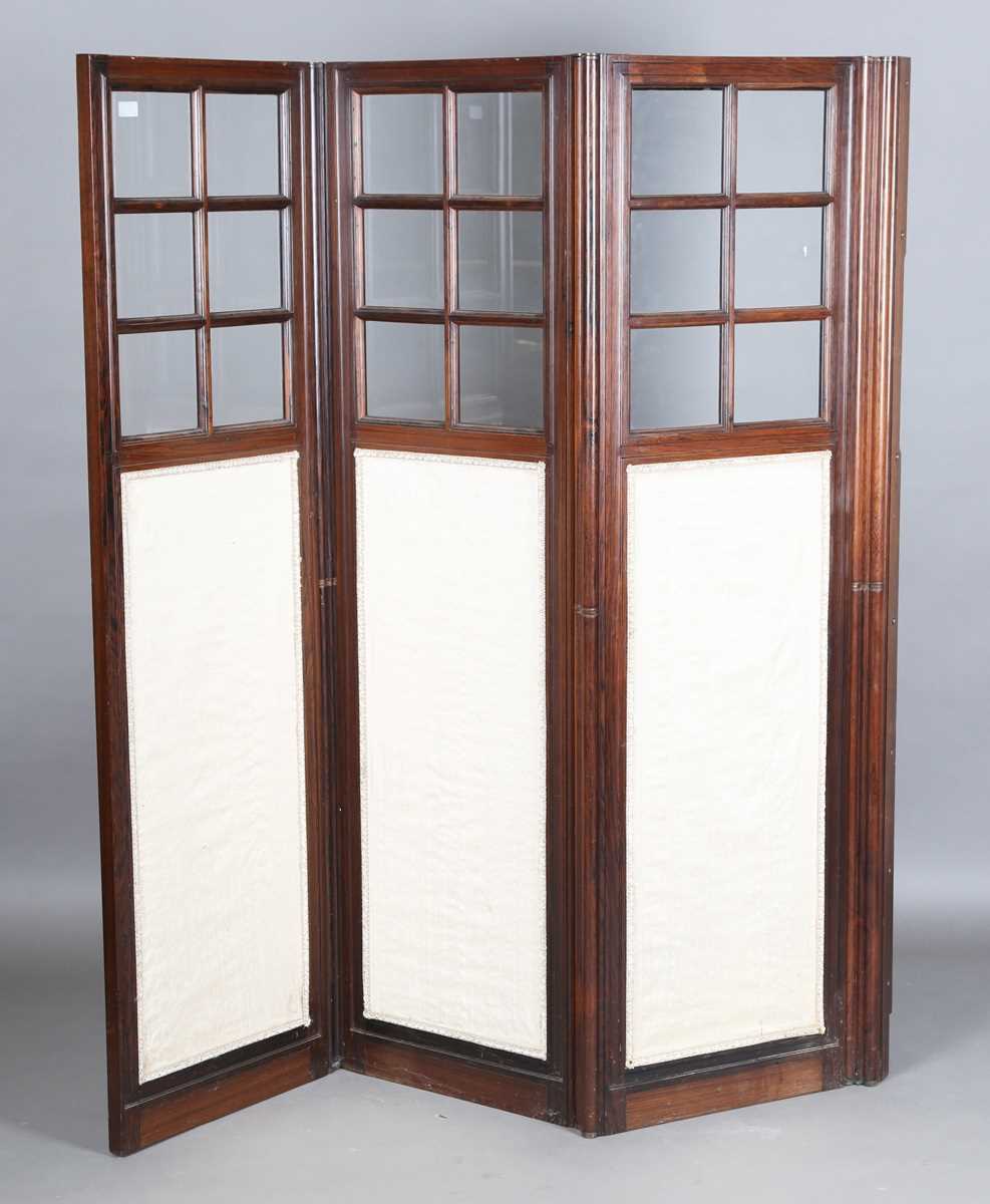 A late 19th century French rosewood three-division draught screen, inset with glass panels and