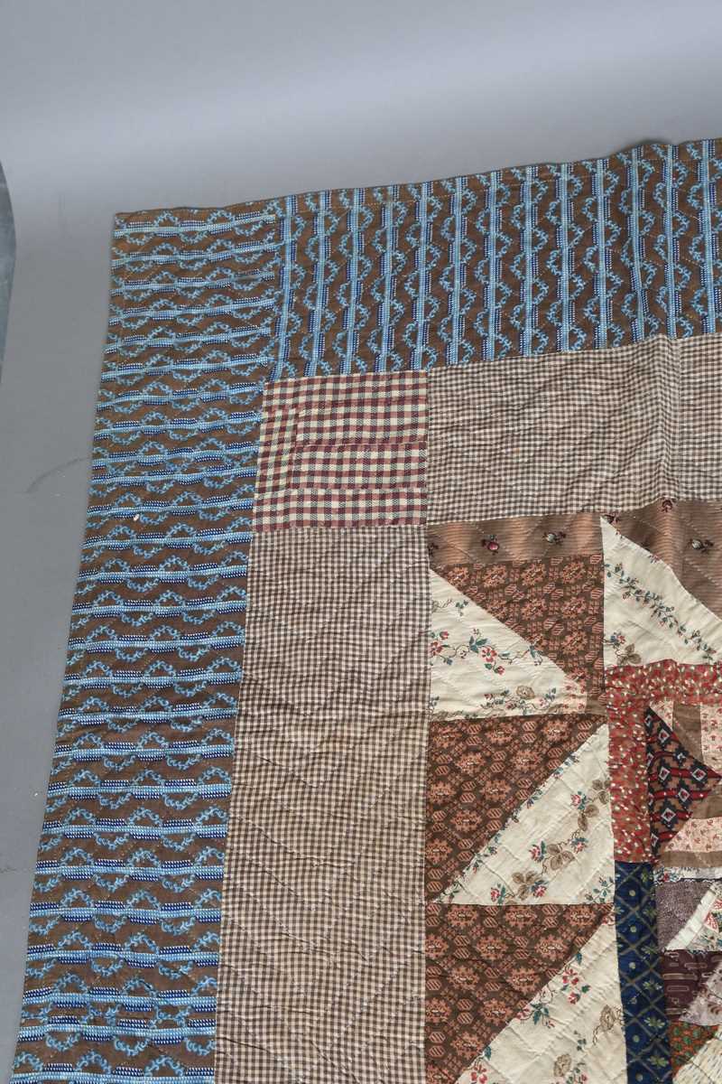 A large mid-19th century cotton 'medallion' patchwork quilt, finely worked with overall printed - Image 7 of 10