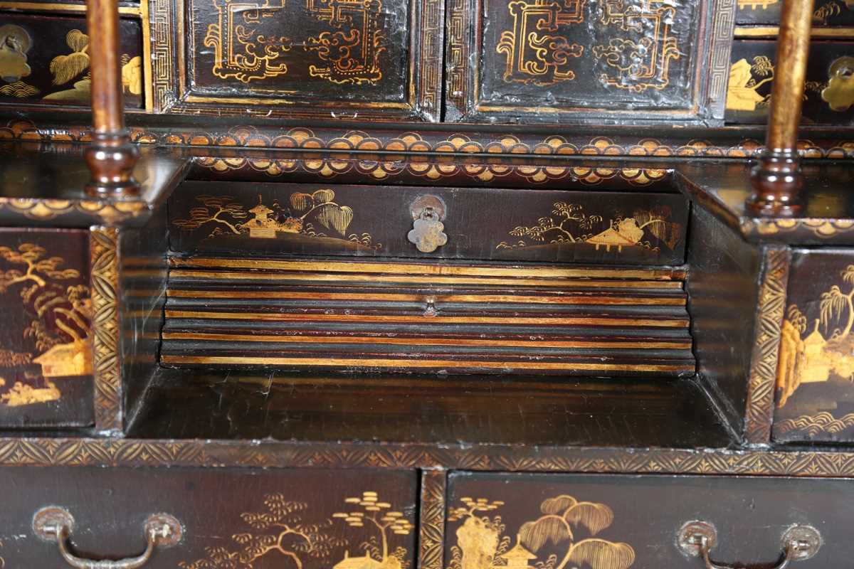 An 18th century Chinese black lacquered collector's cabinet, decorated in gilt with landscape - Image 3 of 28