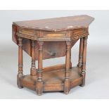 An early 20th century Jacobean Revival oak credence style drop-flap occasional table with