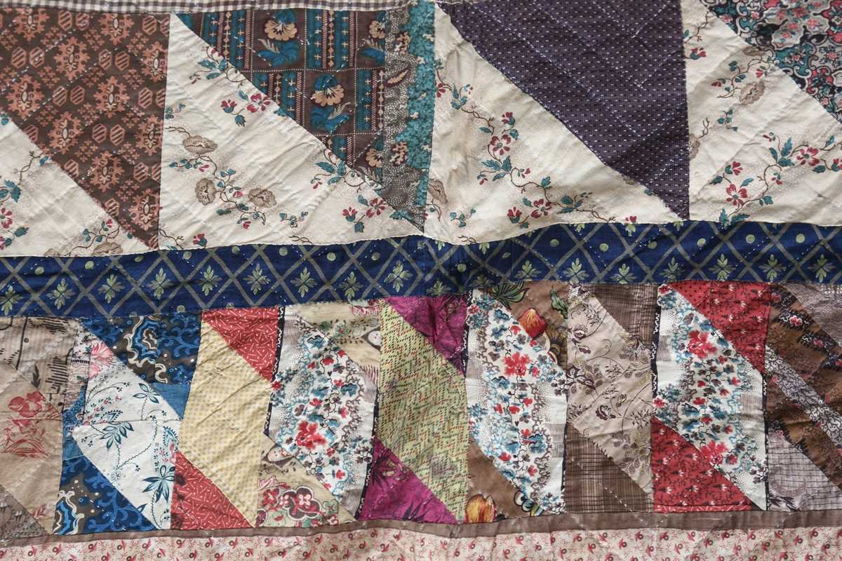 A large mid-19th century cotton 'medallion' patchwork quilt, finely worked with overall printed - Image 6 of 10