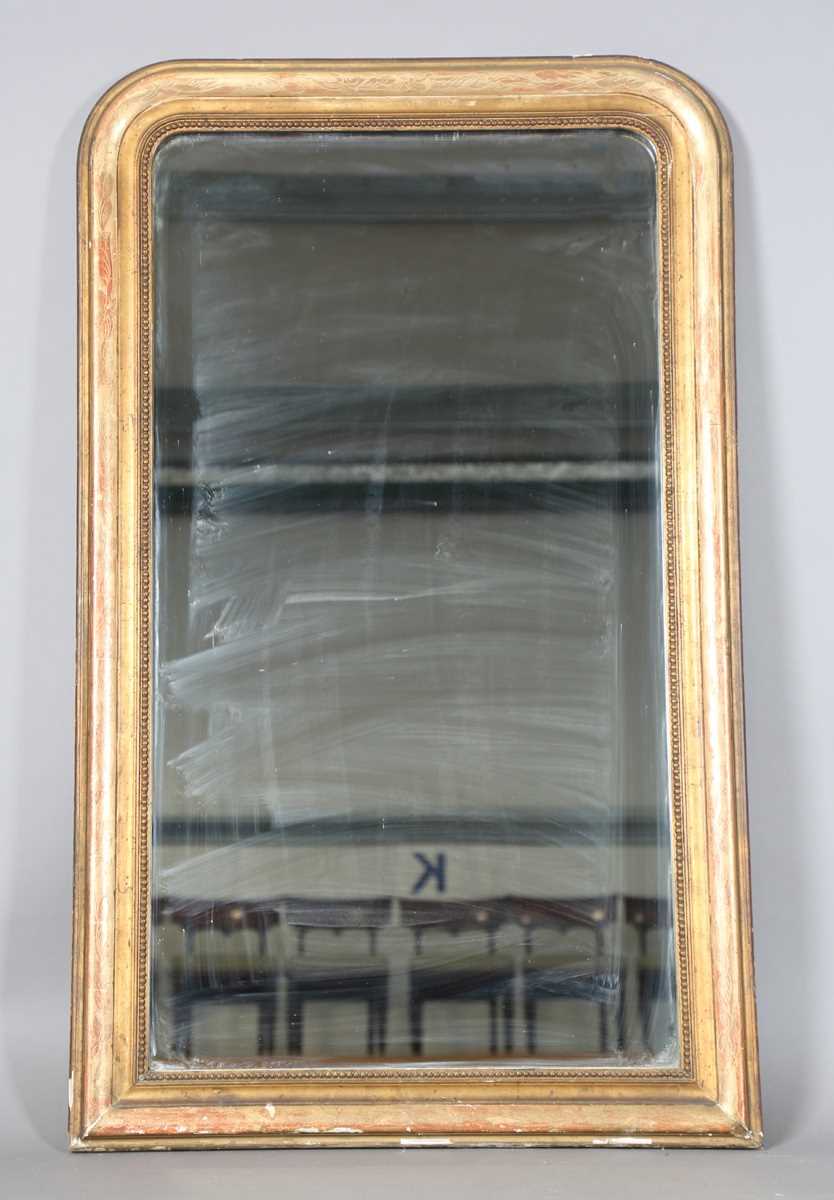 A 19th century French gilt gesso pier mirror with an arched foliate decorated frame, 138cm x 85cm.