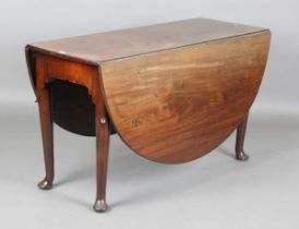 A George III mahogany oval drop-flap breakfast table, the tapering legs with carved lappet shoulders