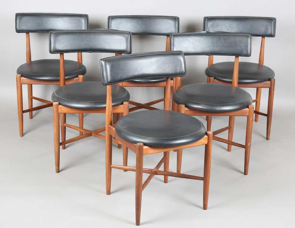 A set of six mid-20th century G-Plan teak framed dining chairs with black leatherette seat and