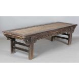 A 19th century Chinese softwood table with woven rattan top above a carved scroll frieze and moulded