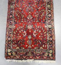 A Hamadan runner, North-west Persia, mid-20th century, the red field with overall scattered foliage,