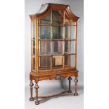 A pair of early/mid-20th century Queen Anne style walnut display cabinets, the arched tops above