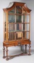 A pair of early/mid-20th century Queen Anne style walnut display cabinets, the arched tops above