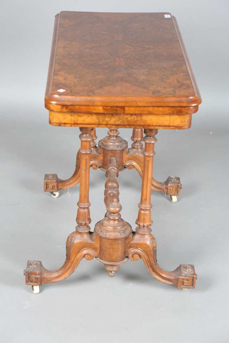 A mid-Victorian burr walnut rectangular fold-over card table, raised on fluted legs and carved feet, - Image 12 of 14