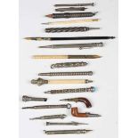 A collection of various propelling pencils and dip pens, including two novelty examples in the