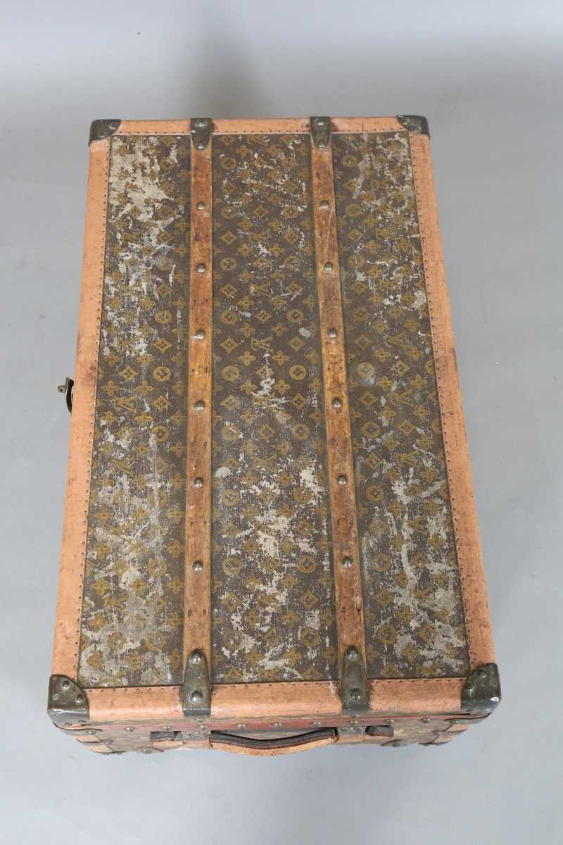 An early 20th century Louis Vuitton travelling trunk with overall monogram canvas covering and tan - Image 42 of 42