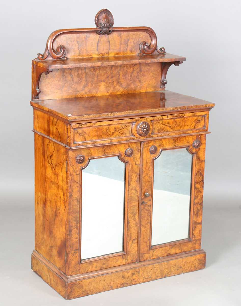 A Victorian burr walnut chiffonier, the shelf back above a drawer and a pair of mirrored doors, on a