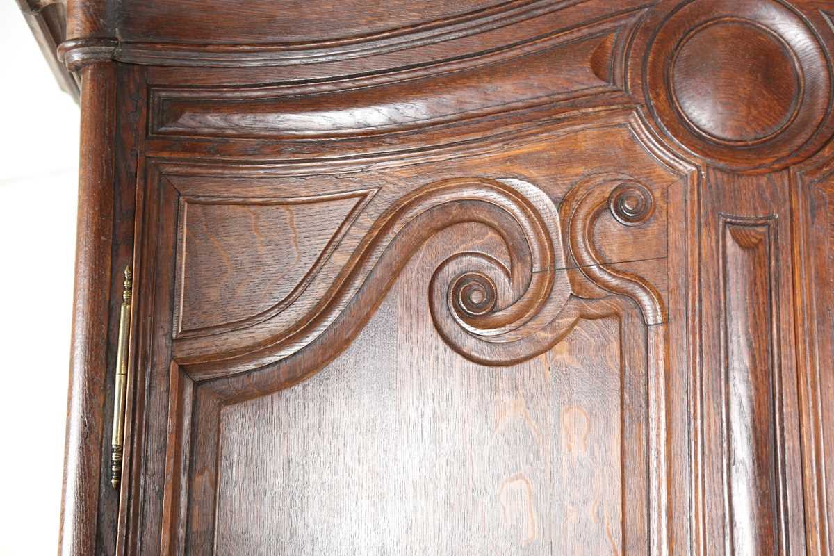 A 19th century French oak side cabinet with an arched pediment and four carved panel doors, height - Image 4 of 14