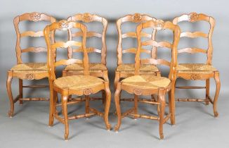 A set of six 20th century French oak ladder back dining chairs with rush seats, height 95cm, width