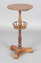 A Victorian rosewood work table, the circular top above a galleried undertier and triform base,