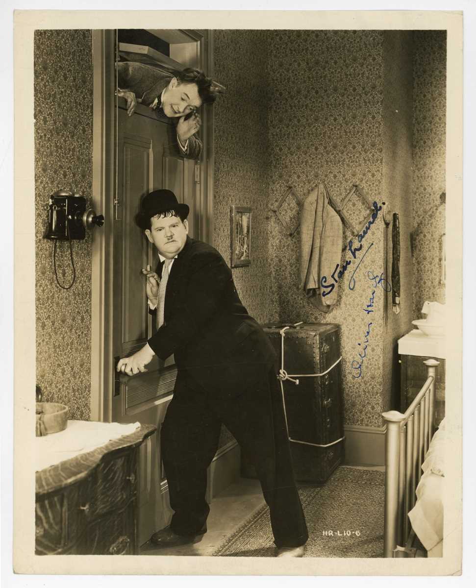 AUTOGRAPH. A signed black and white photograph of Stan Laurel and Oliver Hardy, 25.5cm x 20.5cm,
