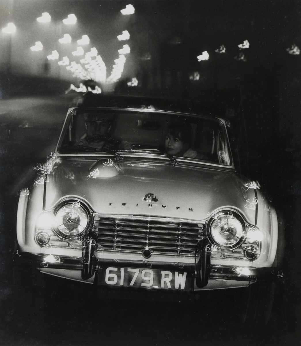 PHOTOGRAPHS. A black and white photograph of a Triumph TR4 driving along a street-lit road, 1960s or - Bild 2 aus 8