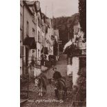 A collection of approximately 60 postcards of the village of Clovelly in Devon, including