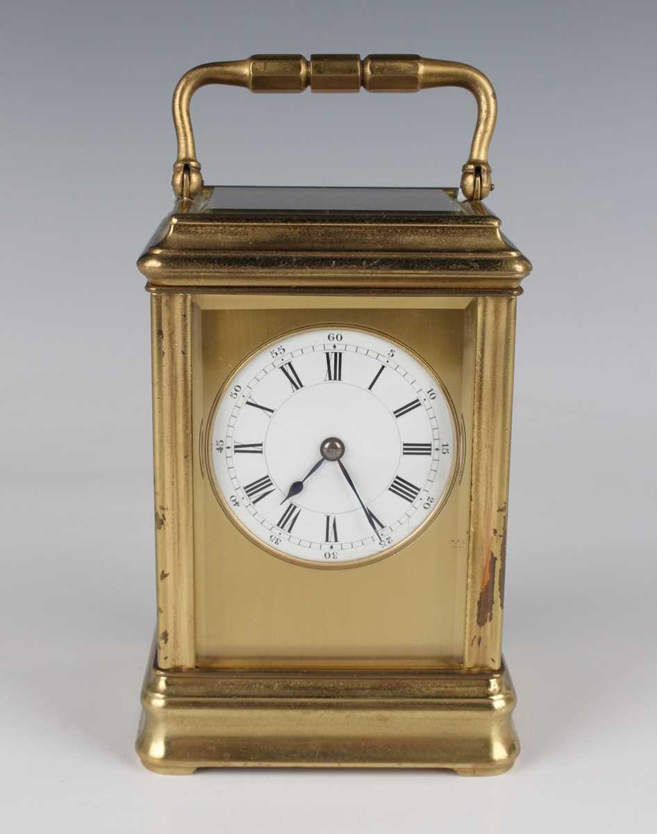 A late 19th century French lacquered brass carriage timepiece with eight day movement, the enamelled