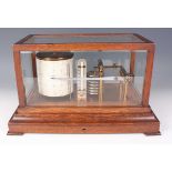 An early 20th century Negretti & Zambra oak cased barograph, the lacquered brass mechanism with