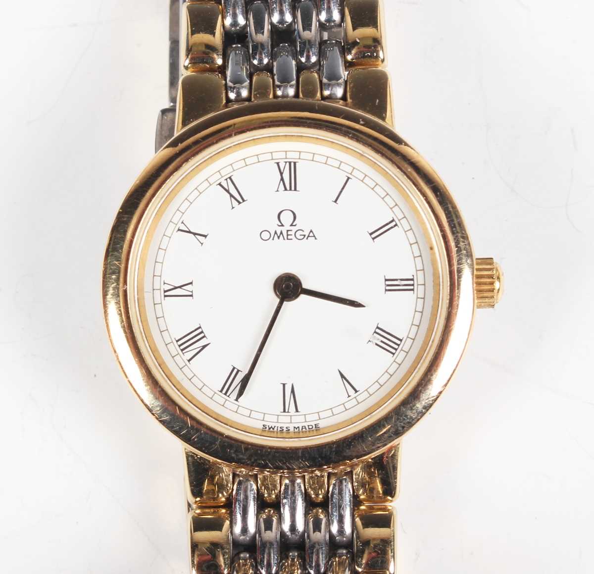 An Omega De Ville steel and gilt lady's bracelet wristwatch with signed dial, the bracelet with