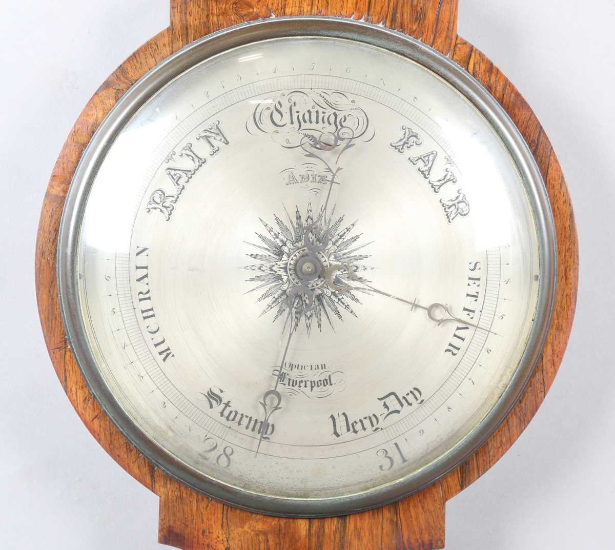 An early Victorian rosewood wheel barometer of oversized proportions with silvered dial,