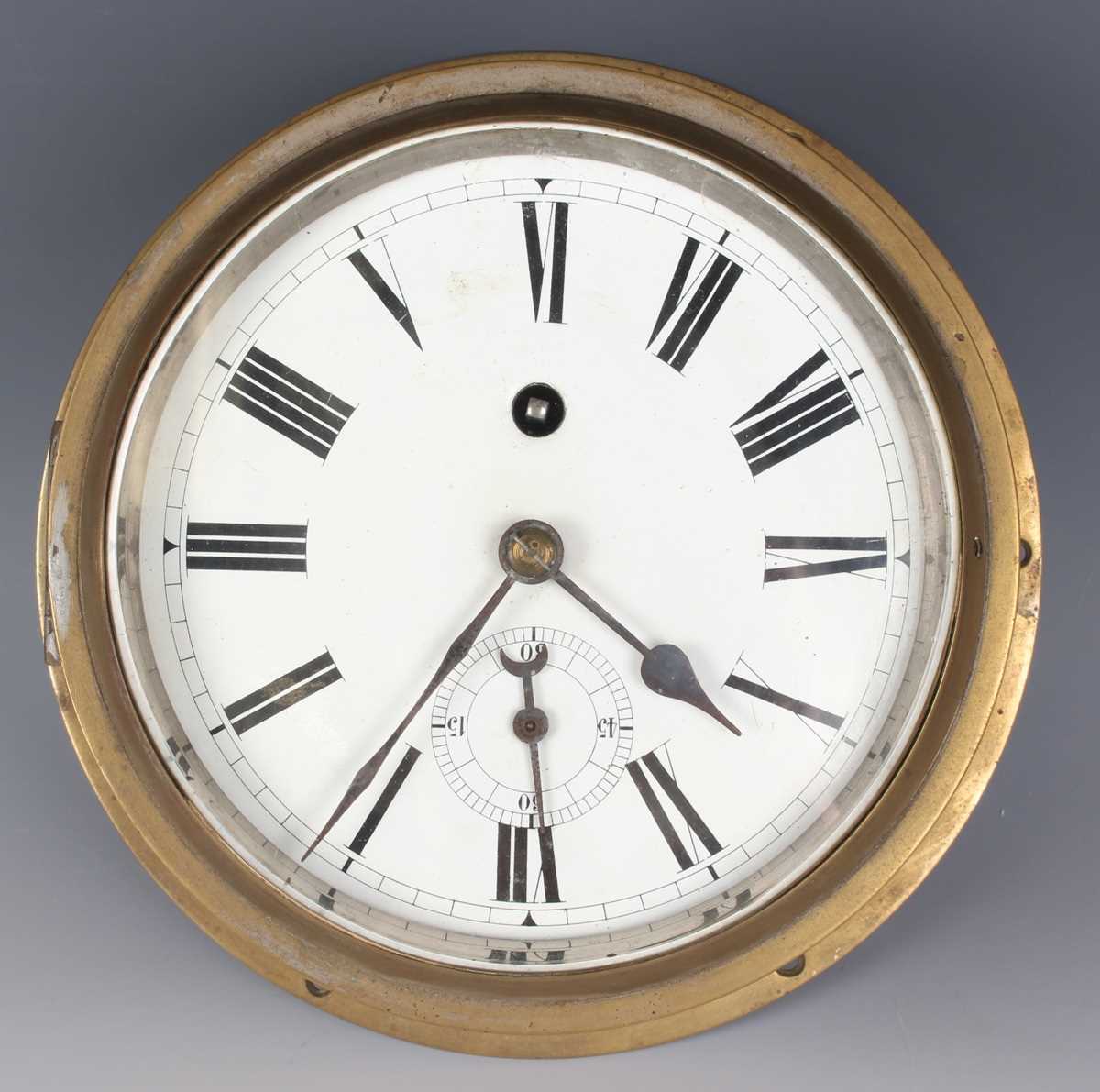An early 20th century brass circular cased ship's style wall timepiece, the 7-inch white enamelled