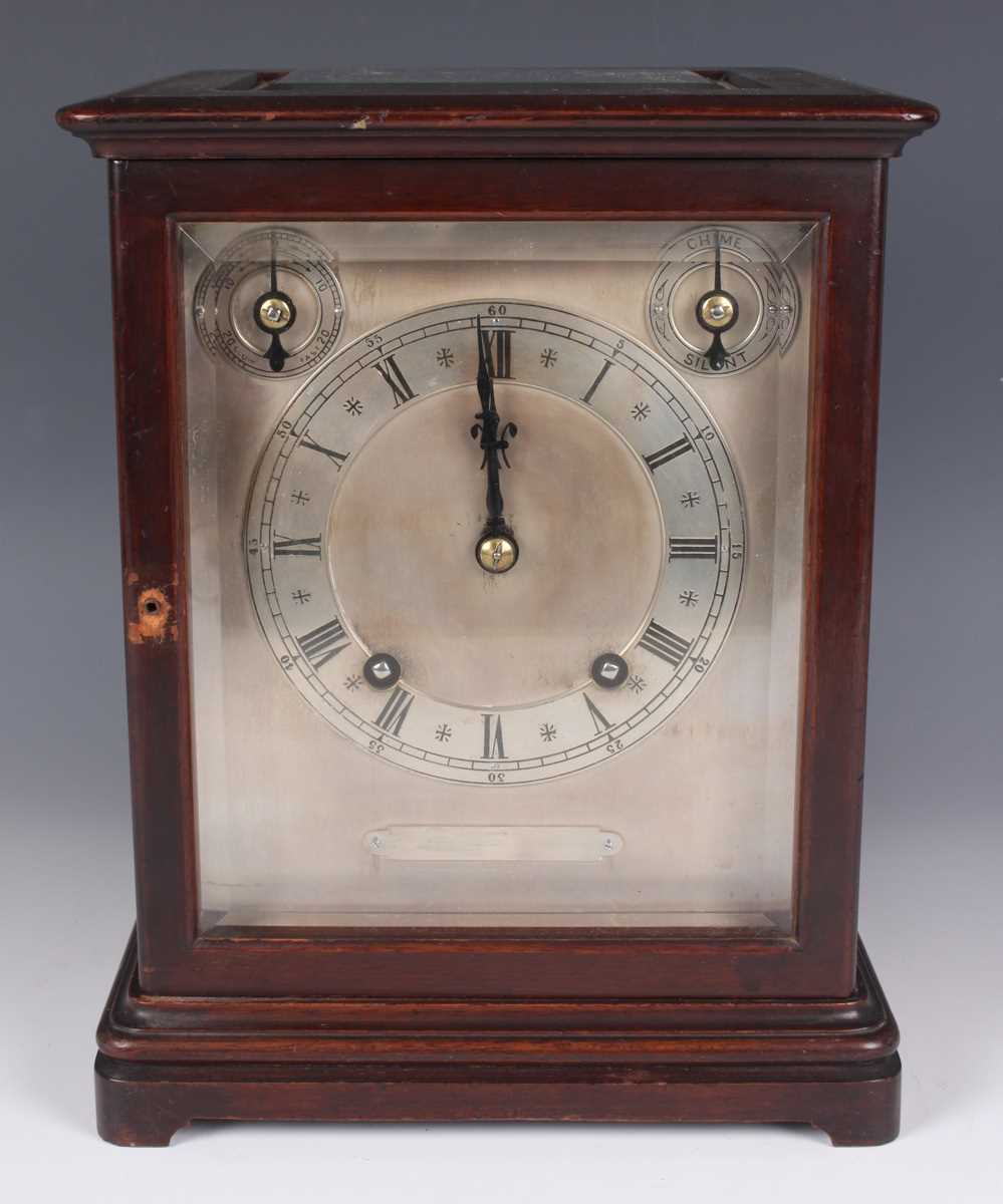 An early 20th century mahogany mantel clock with eight day movement striking on two gongs, the