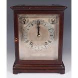 An early 20th century mahogany mantel clock with eight day movement striking on two gongs, the