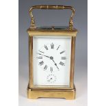 A late 19th century French lacquered brass corniche cased carriage alarm clock by E.G. Lamaille, the